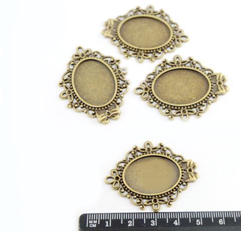 Ажурная основа для кулона, овал с бантиком, цвет - бронза, 4 см